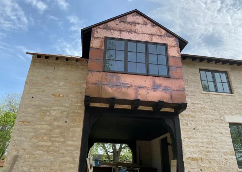 Copper metal panel facade on a stone building for Skylight Installation in Huntley