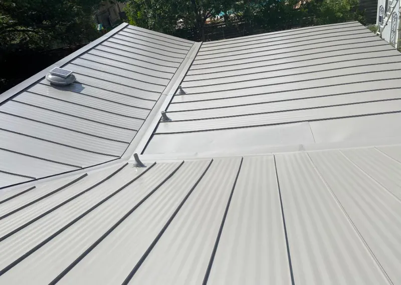 Solar attic fan installed on a metal roof for Roof Ventilation in Huntley
